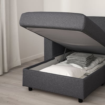 Modern grey sofa with lift-up chaise section revealing storage, ideal for hidden space.