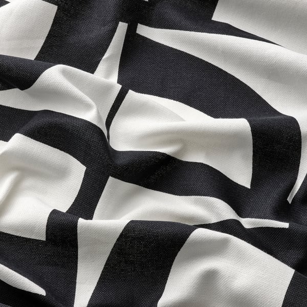 Abstract black and white pattern on soft, textured fabric, wrinkled to show texture and quality.