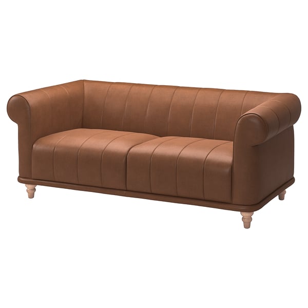 The VISKAFORS sofa is a brown leather couch with rolled arms and a tufted back, exuding classic comfort and elegance.