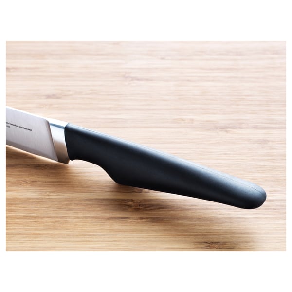 A high-quality kitchen knife with a sharp, stainless steel blade and a comfortable, firm grip handle resting on a wooden surface.