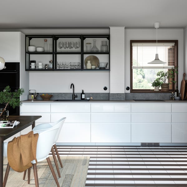 Modern kitchen with white high-gloss cabinets, open shelves, grey countertop, and striped floor tiles.