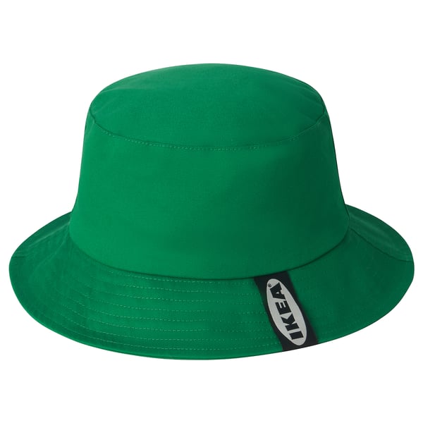 Ljusgrön bucket hat med brett brätte och mörk märkesetikett på sidan.