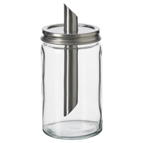 En tom, genomskinlig sockerkarkar, med lock i rostfritt stål och innertub i metall, designad av IKEA.