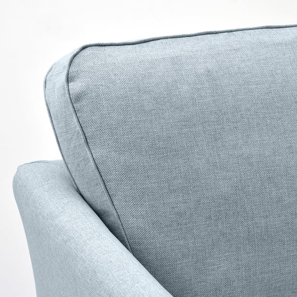 Plyschtexturerad soffa med eleganta linjer och robust konstruktion.