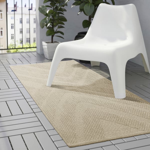 Minimalistisk vit FULLMAKT stol på stor beige matta, perfekt för utomhus på grått kakel.