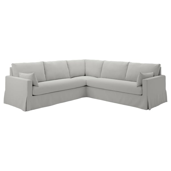 Ljusgrå hörnsoffa, ren modern design med kuddar, bekväm för avkoppling.