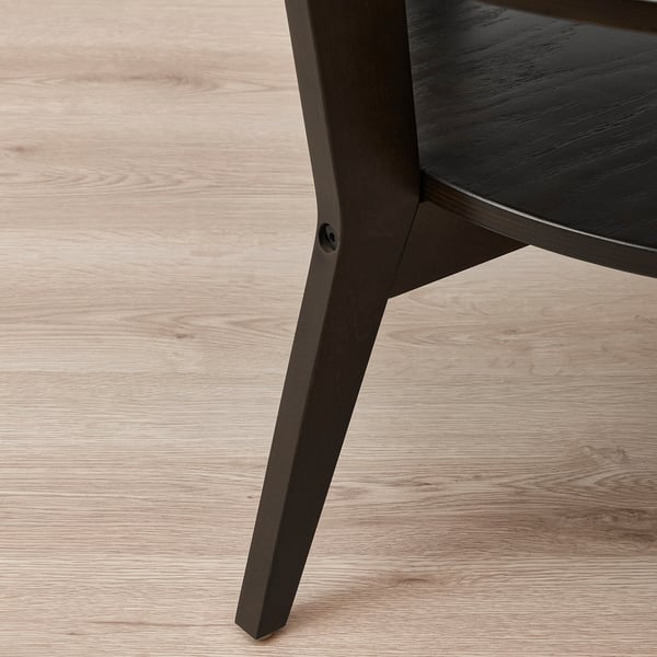 Modernt soffbord med mörk träfinish. Eleganta, stadiga ben och en rund topp. Designad för hållbarhet och stil.