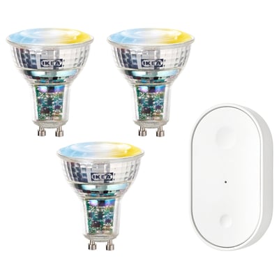 Tre färgglada ikea smarta glödlampor och en vit fjärrkontroll.