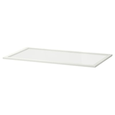 En vit hylla i KOMPLEMENT-glas. Den är rektangulär, tillverkad av träfiberskiva och härdat glas, med en ren, modern design.