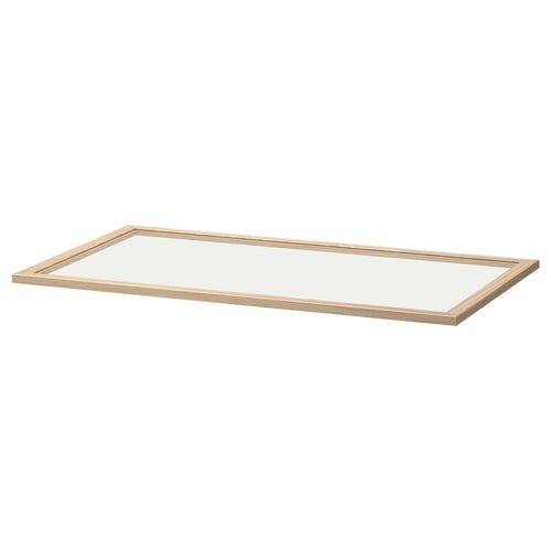 En ikea KOMPLEMENT hylla i ljusglas i klar. Den har en ljus träram och en genomskinlig glasyta.