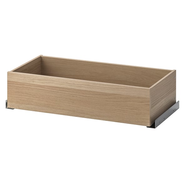 En ikea KOMPLEMENT trälåda, ljusbrun, rektangulär, med ett minimalistiskt utseende. Det är en mekanism för långsam stängning.