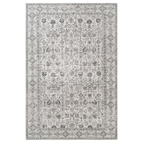 Localtåg gråzonsmatta med intrikata blommönster, rektangulär form, gjord av återvunnen polyester.