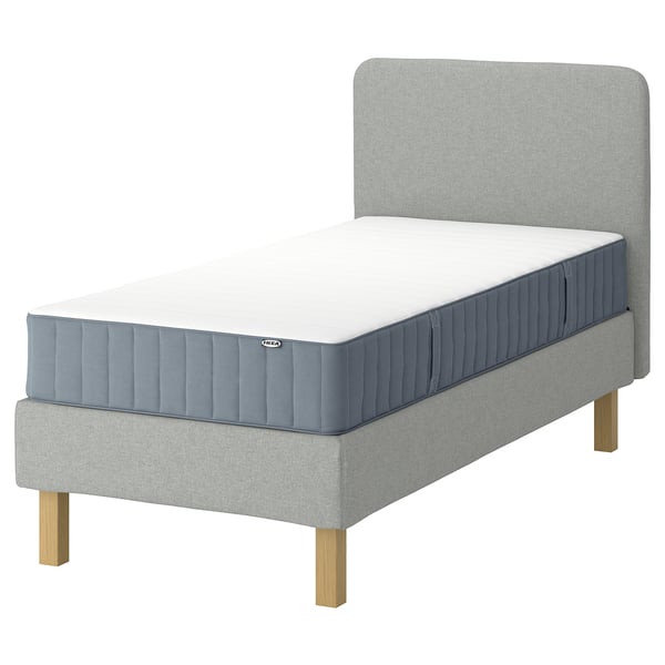 IKEA LYNGÖR, grå säng med vit madrass, träben, stoppad sänggavel.