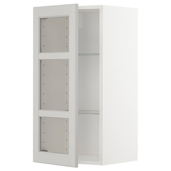 Vitt väggskåp med glashyllor. Modern design, justerbara hyllor, robust ram.