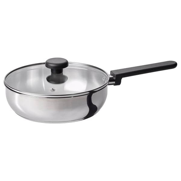 Traktörpanna i silver med svart handtag och glaslock, modern design.