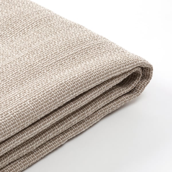Vikt beige tyg, texturerad väv synlig, ser mjuk ut, troligen en kudde eller filt.