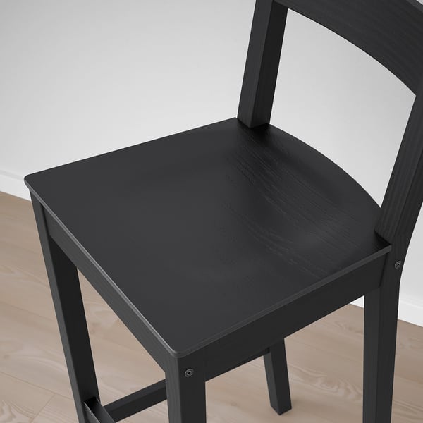 Svart trästol med ett böjt ryggstöd och ett fotstöd, designad för komfort och hållbarhet.