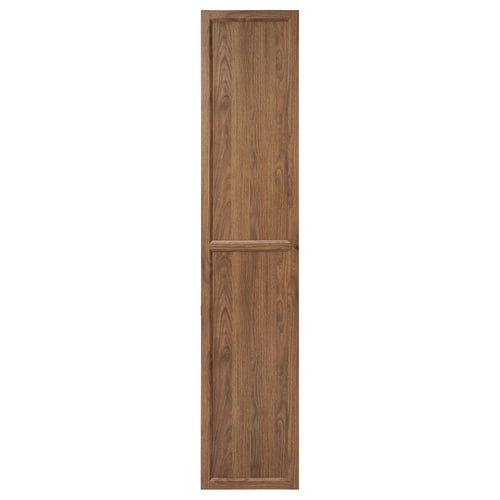 Ett högt, brunt förvaringsskåp i trä med en dörr med en panel, designad för att fästas på en bokhylla.
