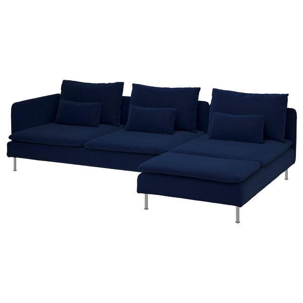 Mörkblå l-formad soffa med plyschkuddar och kromade ben.