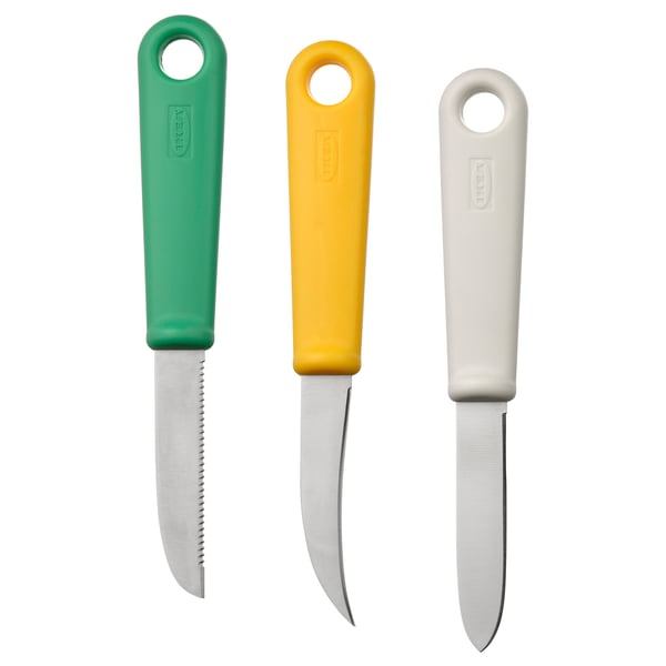 Tre färgglada knivar i grönt, gult och vitt med ergonomiska handtag och blad i rostfritt stål, arrangerade vertikalt.