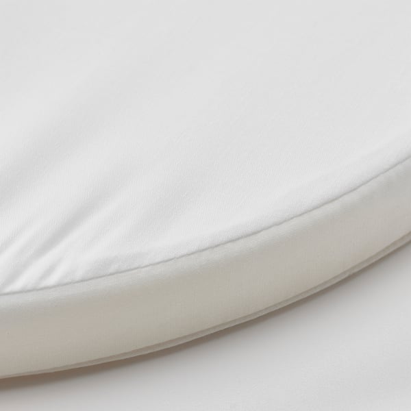 Circular, white baby mattress with smooth, adjustable fabric and simple design.
