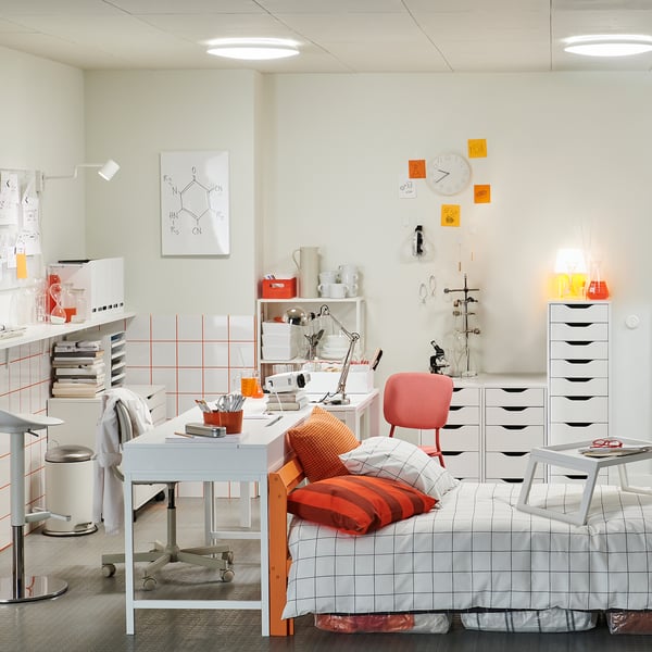 Organised dorm with white ALEX storage unit against wall.