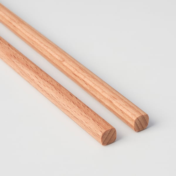 Pair of wooden chopsticks on white background. Well-polished, seamless joints, solid craftsmanship.