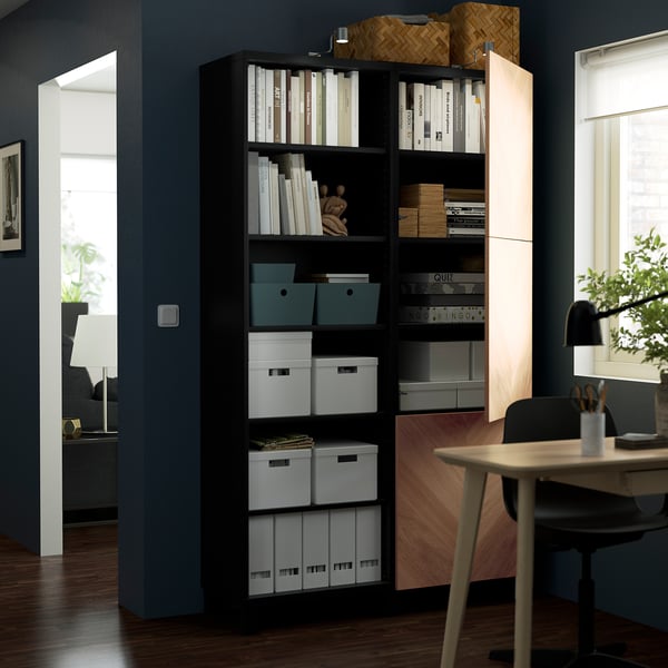 Modern home office with BESTÅ black storage, adjustable shelves and push-open door.