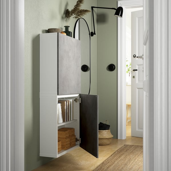 Modern BESTÅ wall cabinet with open door showing books & baskets, ideal for small spaces.