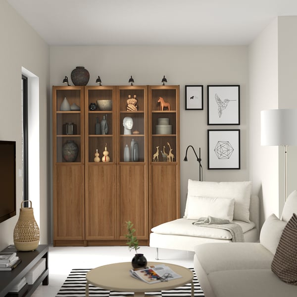 Modern living room with BILLY bookcase, sofa, lamp, coffee table, and art.