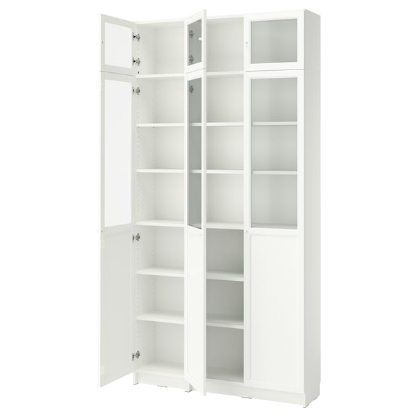 A white BILLY bookcase with glass doors and adjustable shelves.