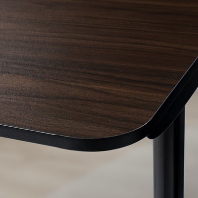 A close-up of a durable, dark wood-finished tabletop with sleek, rounded edges, supported by sturdy black metal legs.