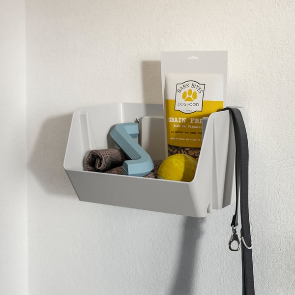 Wall-mounted pet organiser with dog treats, leash, and toys.