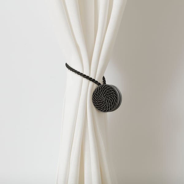 Magnetic curtain tie-back; keeps curtains open without wall damage.