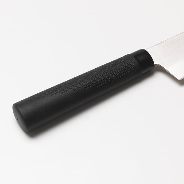 Close-up of a spatula with a black, textured handle and a shiny blade, suggesting high quality and durability.