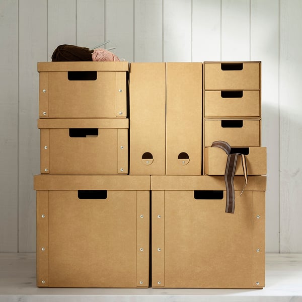 Stacked GÄRDESGÅRD storage boxes in brown cardboard, some open showing yarn, sturdy handles.