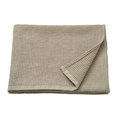 A beige, folded GULLDYNA towel made of 50% recycled cotton with a textured weave.