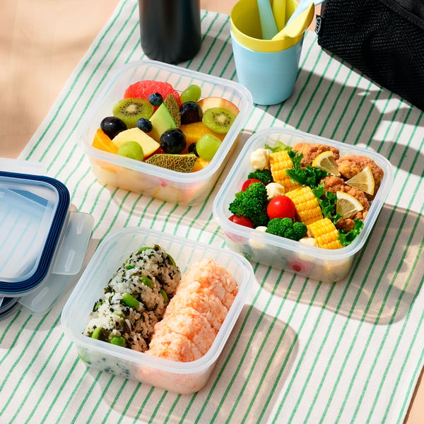 Three plastic containers with food: fruit mix, rice and vegetables, and chicken with veggies. Lid locks for carrying.