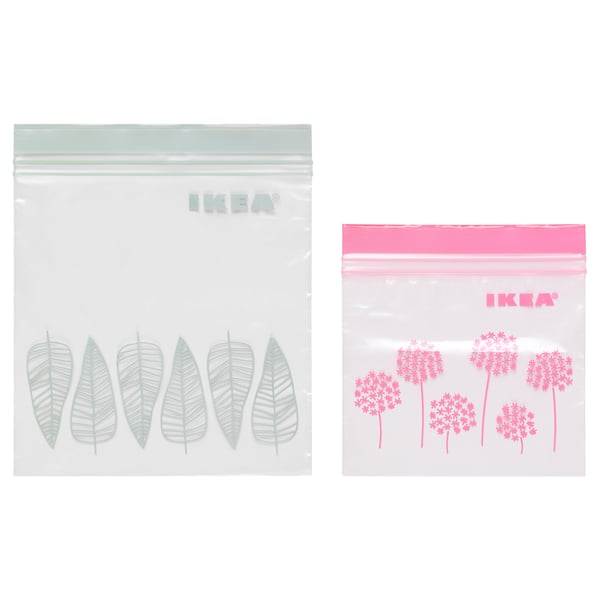 Two IKEA ISTAD resealable bags, one with green leaf designs, the other with pink floral patterns. Both are transparent with double seals.