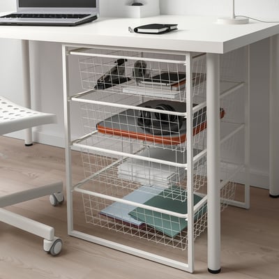 White JONAXEL storage unit with 5 shelves under desk, organising folders, laptop, and office supplies.