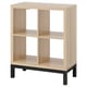 Light wood KALLAX shelving unit, black legs, four open cubes, minimalist design.