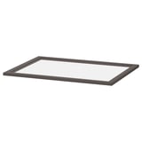 A dark-colored rectangular glass shelf by IKEA. The frame is made of fibreboard with a sleek design, suitable for modern storage solutions.
