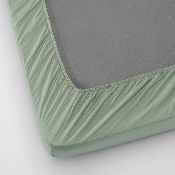 Green fitted sheet with elastic edges for thick mattresses, smooth lyocell fabric for cool nights.