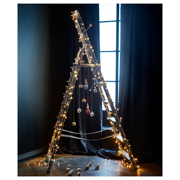 Unique led christmas tree, triangular with lights, no tree. Black background, warm glow.