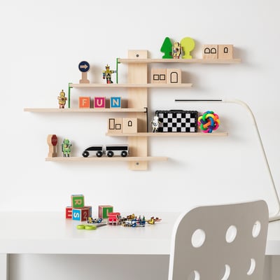 LUSTIGT toy shelf with wooden shelves and plastic ladders against a white wall.