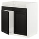 Modern black kitchen cabinet with white frame, bevelled edges, sturdy wood.