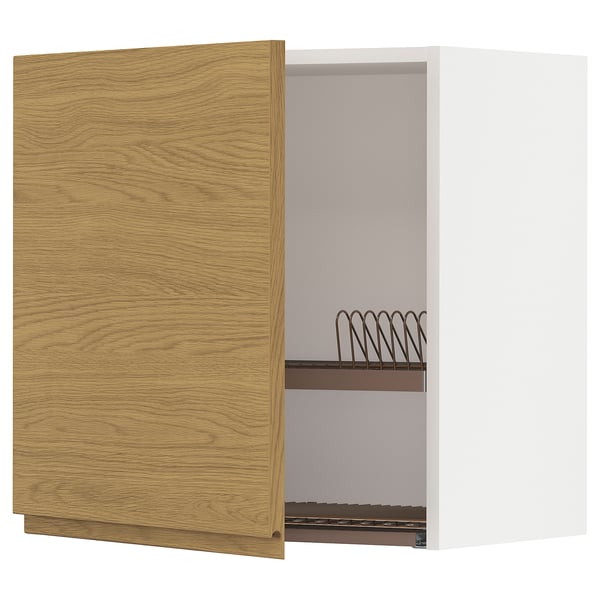 A wooden kitchen cabinet with an open door, revealing metal racks inside.