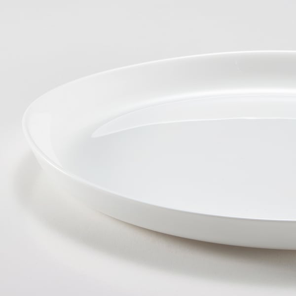 Smooth, pristine white plate with glossy finish, slightly curved edges, clean minimalist design.
