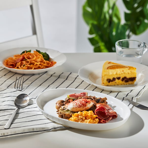 Three plates with spaghetti, cake, and breakfast, cutlery, versatile for casual or formal meals, safe for dishwasher and microwave.
