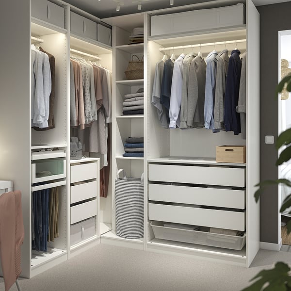 Large PAX walk-in closet with shelves, drawers, and lighting for a modern, minimalist look.
